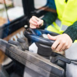 Woman forklift truck driver in an industrial area.